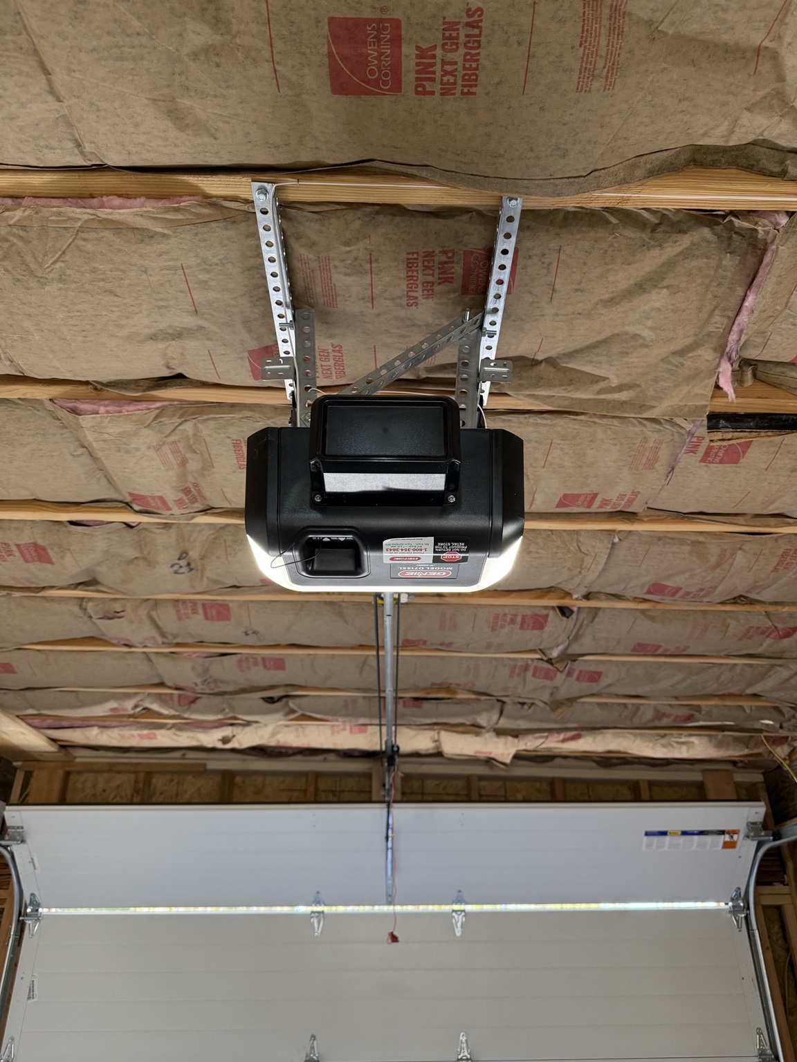 Close-up of ceiling-mounted garage door opener and support brackets