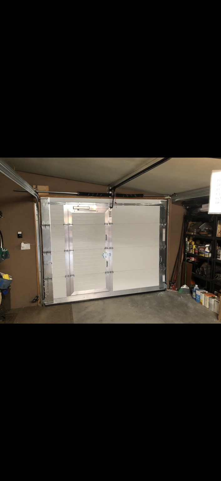 Interior view of a sectional garage door with an integrated pedestrian door